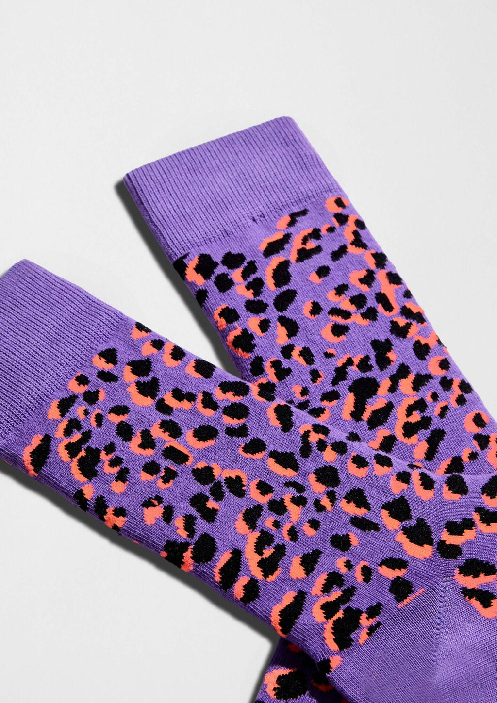 Calcetines BeCamo Purple con diseño de manchas negras y naranjas sobre fondo morado - BESOCKS