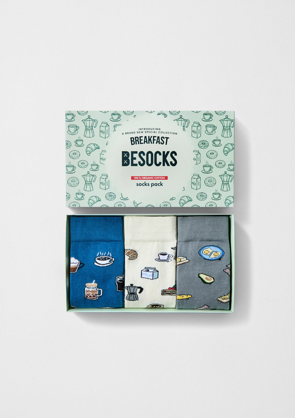 Pack Breakfast de BESOCKS con tres calcetines: diseños de café, leche y brunch en colores azul, crudo y gris.