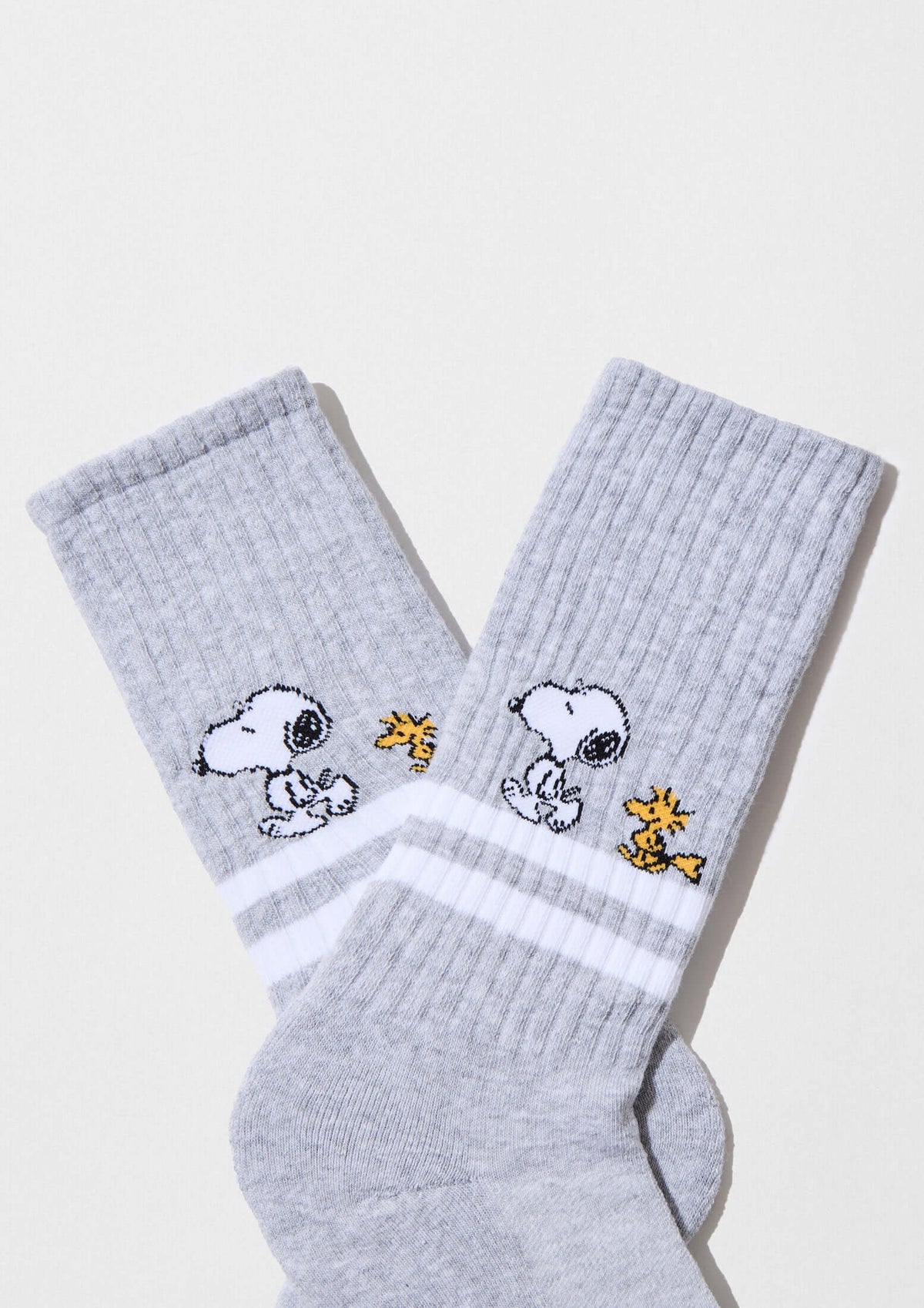 Calcetines altos BeSnoopy Stripes Grey con Snoopy y Woodstock en gris y franjas blancas, confeccionados en algodón orgánico.