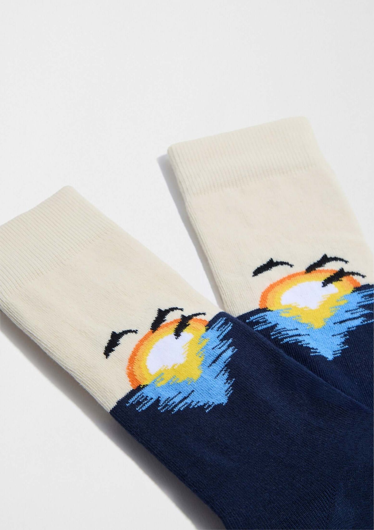 Calcetines BeSunset en azul marino con diseño gráfico de atardecer sobre el mar en tonos cálidos y vegetación.