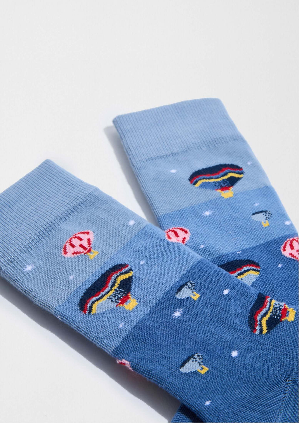 Calcetines BeSkyJourney en tonos azules con dibujos de globos aerostáticos y elementos gráficos en algodón orgánico.