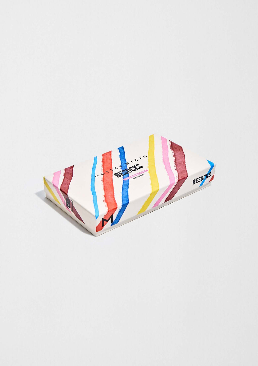 Pack MOISES NIETO x BESOCKS en caja con diseño a rayas verticales en colores azul, rosa y amarillo.