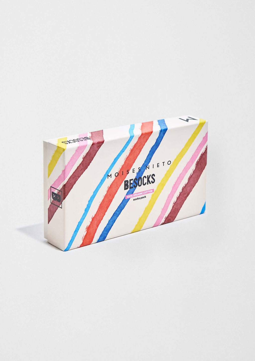Pack MOISES NIETO x BESOCKS en caja con diseño a rayas en tonos rosa, azul y amarillo, colaboración de calcetines originales.
